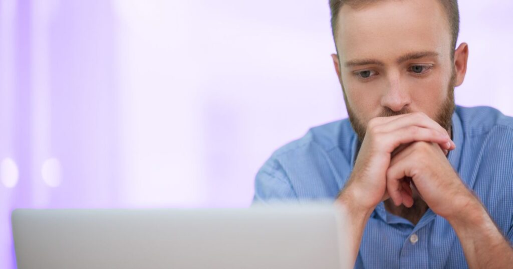 Un homme perplexe devant son ordinateur : comment apprendre des données par coeur ?