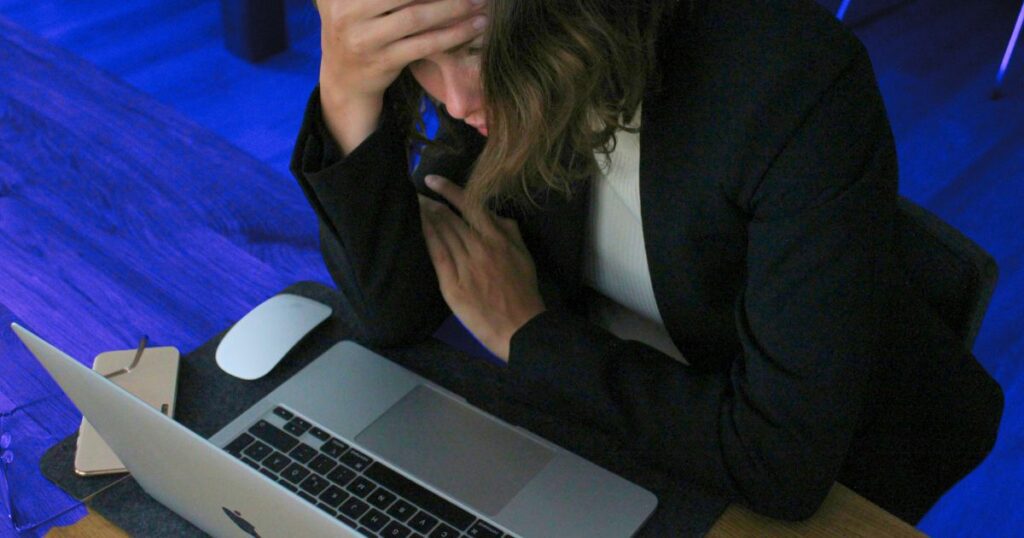 Femme inquiète devant son ordinateur, illustrant une émotion générée par l'amygdale